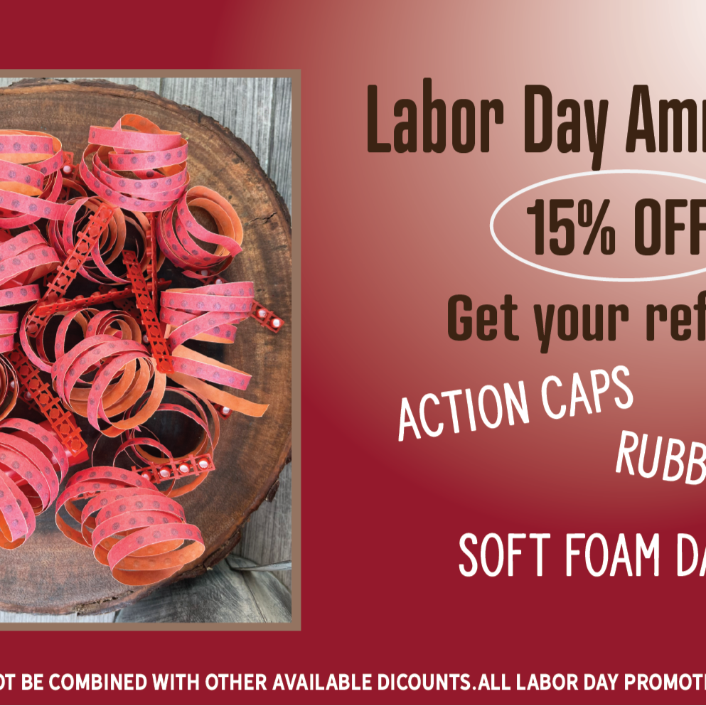 Promotional flyer for a Labor Day Ammo Sale with action caps, rubber bands, and soft foam darts on a wooden board.